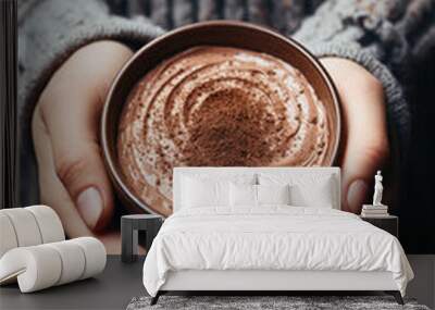 Female hands holding a cup of hot chocolate with cocoa powder, close up. Wall mural