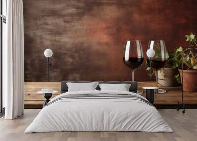 Two glasses of red wine on wooden table over rustic background. Wall mural