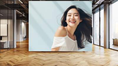 Young happy smiling Asian woman model wearing tshirt looking at camera on color background. Face skin hair care korean cosmetic and makeup, fashion ads. Beauty portrait. White t-shirt mock up template Wall mural