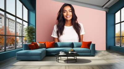 Young happy smiling Indian woman model wearing tshirt looking at camera standing on color background. Face skin care cosmetics makeup, fashion ads. Beauty portrait. White t-shirt mock up template . Wall mural