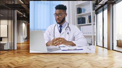 African American doctor counselling patient via video call, telemedicine sector Wall mural