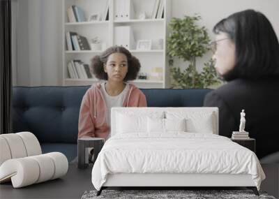 Therapist talking to sad teen girl during counselling session, mental health Wall mural