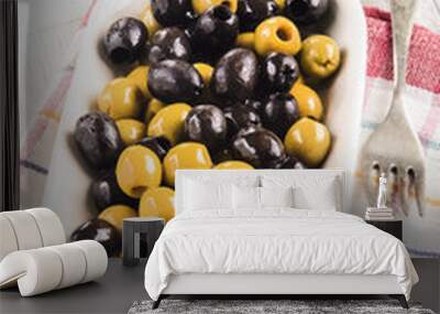 white bowl with oily green and black olives, tomato background, Wall mural