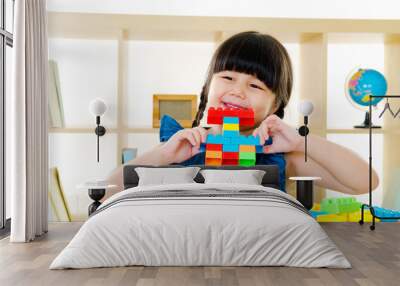 Asian kid piling up building blocks Wall mural