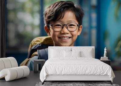 Close-up portrait of an asian boy with backpack and glasses, smiling and happy, against a school blue background. Back to school concept generative ai Wall mural