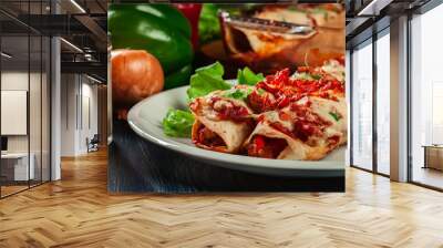 Traditional mexican enchiladas with chicken meat, spicy tomato sauce and cheese on a plate Wall mural