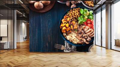 Vegetable buddha bowl lunch with chicken and quinoa, chickpea, mushrooms, lettuce and tomatoes Wall mural