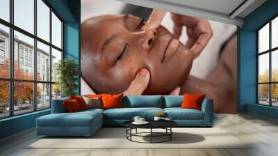 Black woman, relax massage and facial spa treatment of a young female face with serum. Skincare, beauty and wellness clinic with client feeling calm and zen from dermatology or cosmetic chemical peel Wall mural