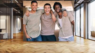 Portrait, diversity and happy with friends standing outdoor together while feeling excited in the city. Freedom, friendship or smile with a group of young people posing outside on an urban background Wall mural