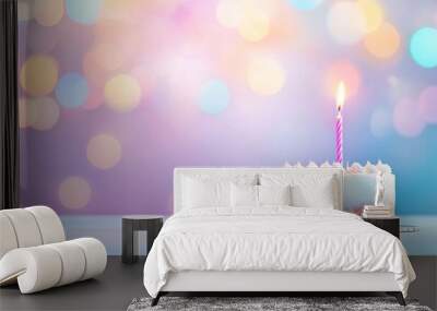 A single birthday cake with a lit candle against a colorful bokeh background during a festive celebration, banner Wall mural