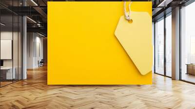 Bright yellow tag on a vibrant yellow background for labeling gifts or seasonal sales Wall mural