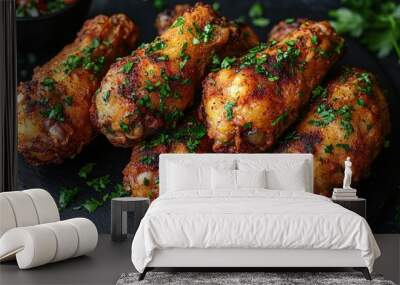 Overhead shot of crispy golden fried chicken on a black plate. Wall mural