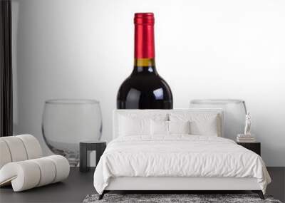 Unopened bottle of red wine and glasses isolated on white  Wall mural