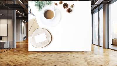 Christmas stationery composition. Cup of coffee, pine cones, Christmas tree branches and vintage scissors. White table background. Blank card mock-up, on round wood cutting board. Flat lay, top view. Wall mural