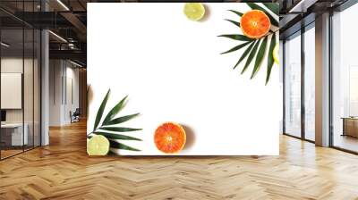 Exotic composition of fresh lemons, red oranges, lime fruit and lush green palm leaves isolated on white table background. Tropical summer vacation concept. Flat lay, top view. Decorative frame. Wall mural