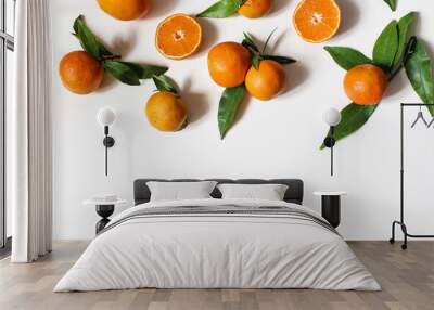 Fresh oranges, tangerines. Whole and cut fruits with green leaves isolated on white table backgrounds. Healthy raw food concept. Summer frame, web banner. Flat lay, top view. Wall mural