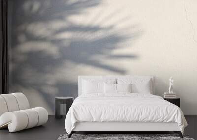 palm tree shadows on beige concrete rough textured background. dark silhouette of the exotic leaves  Wall mural