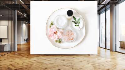 Styled beauty composition. Skin cream, shampoo bottle, rose flowers and Himalayan salt. White table background. Organic cosmetics, spa concept. Empty space, flat lay, top view, web banner. Wall mural