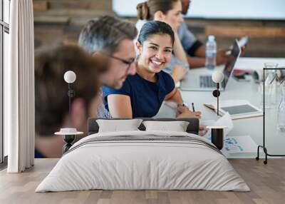 Portrait, happy and a business woman in the boardroom with her team during a meeting for planning. Smile, strategy or collaboration with a female employee and colleagues in the office for a workshop Wall mural