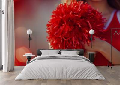 Cheerleader in red uniform with pom pom supporting sport team Wall mural