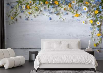 Spring flowers of lilies of the valley, forget me not, daisies on a white  wooden background Wall mural