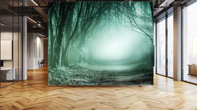 Misty forest pathway shrouded in eerie blue tones Wall mural