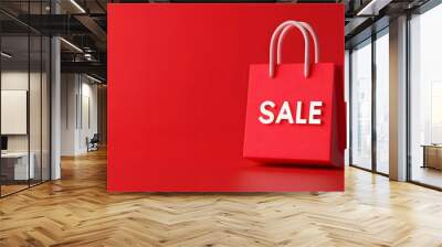 Red sale shopping bag on solid red background. Perfect for marketing promotions, sales announcements, and ecommerce advertisements. Wall mural