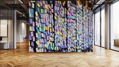 Colorful sticky notes with a variety of messages and emojis are seen on a storefront window at a university campus before graduation day. Wall mural