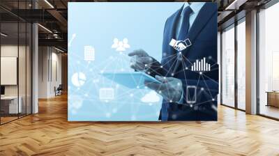 Business management and network technology. Businessperson using tablet computer. Network structure and business icons. Wall mural