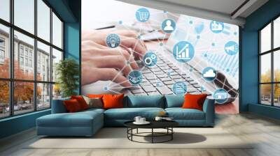 Businessman using laptop for analyzing data. Enterprise resource planning concept. Business structure and many business icons. Wall mural