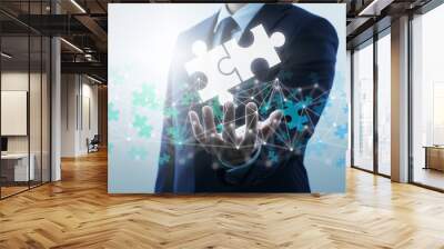 Finding business solution on internet. Businessperson connecting two jigsaw puzzle pieces. Wall mural