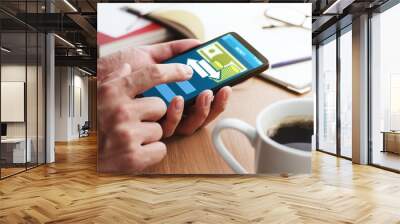 Using smartphone for money transfer and banking.Closeup of male hands touching smartphone screen for using app at table. Wall mural