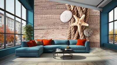 rope, starfish, sea stones on the old wooden background Wall mural