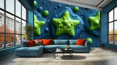 Colorful green and blue star shapes with liquid paint on a textured surface. Wall mural