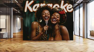 Two joyful African American women singing together in a fun karaoke setting. Wall mural