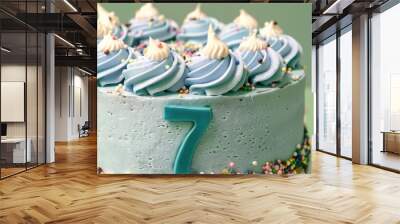 A funfetti birthday cake with the number 7 in pastel blue icing, sprinkled with confetti on a mint green background. Wall mural