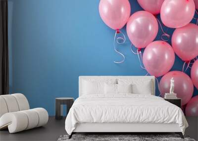 Many pink balloons isolated on the right of a blue background with empty copy space for text. Wall mural