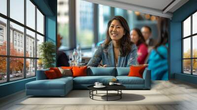 An Asian American businesswoman leading a meeting with a diverse team Wall mural