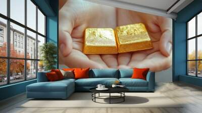 Hands presenting two gold bars on a neutral backdrop with a sense of luxury Wall mural