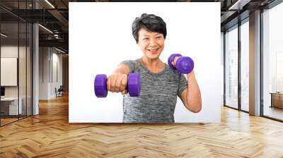 Attractive senior fitness asian woman training, exercising at home with dumbbells isolated on white background. Wall mural