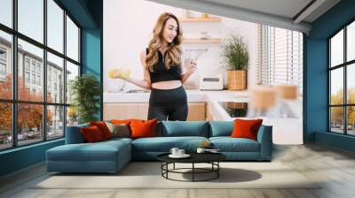 happy woman holding cooking exercising tool in kitchen. beautiful girl suggest people eating smart food and exercising for healthy lifestyle concept. woman control diet and workout training for body Wall mural