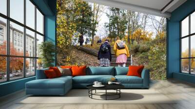 Two young woman walking on the steps. Famous park in city center of Vilnius, Autumn and fall trees and leaves. Wall mural