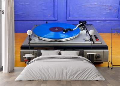 Vintage turntable vinyl record player with blue vinyl Wall mural