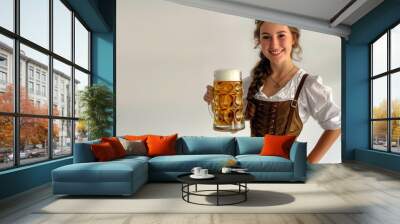 Germany Oktoberfest 20-something woman with a smile and bright eyes, holding handle of a large mug of beer Wall mural