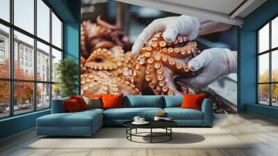 The chef holds an octopus in his hands to prepare a delicious seafood dish Wall mural