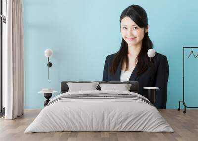 portrait of asian businesswoman on blue background Wall mural