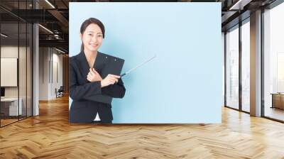 portrait of asian businesswoman on blue background Wall mural