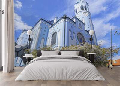 The Blue Church (Elizabeth Church) from a lower perspective, with a flowering tree in the foreground, in the sun, Slovakia, Bratislava, wide angle lens Wall mural