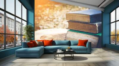 Ancient books on a wooden table , literacy and knowledge concept Wall mural