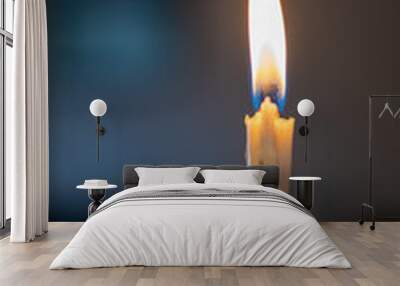 burning candle with a dark background Wall mural